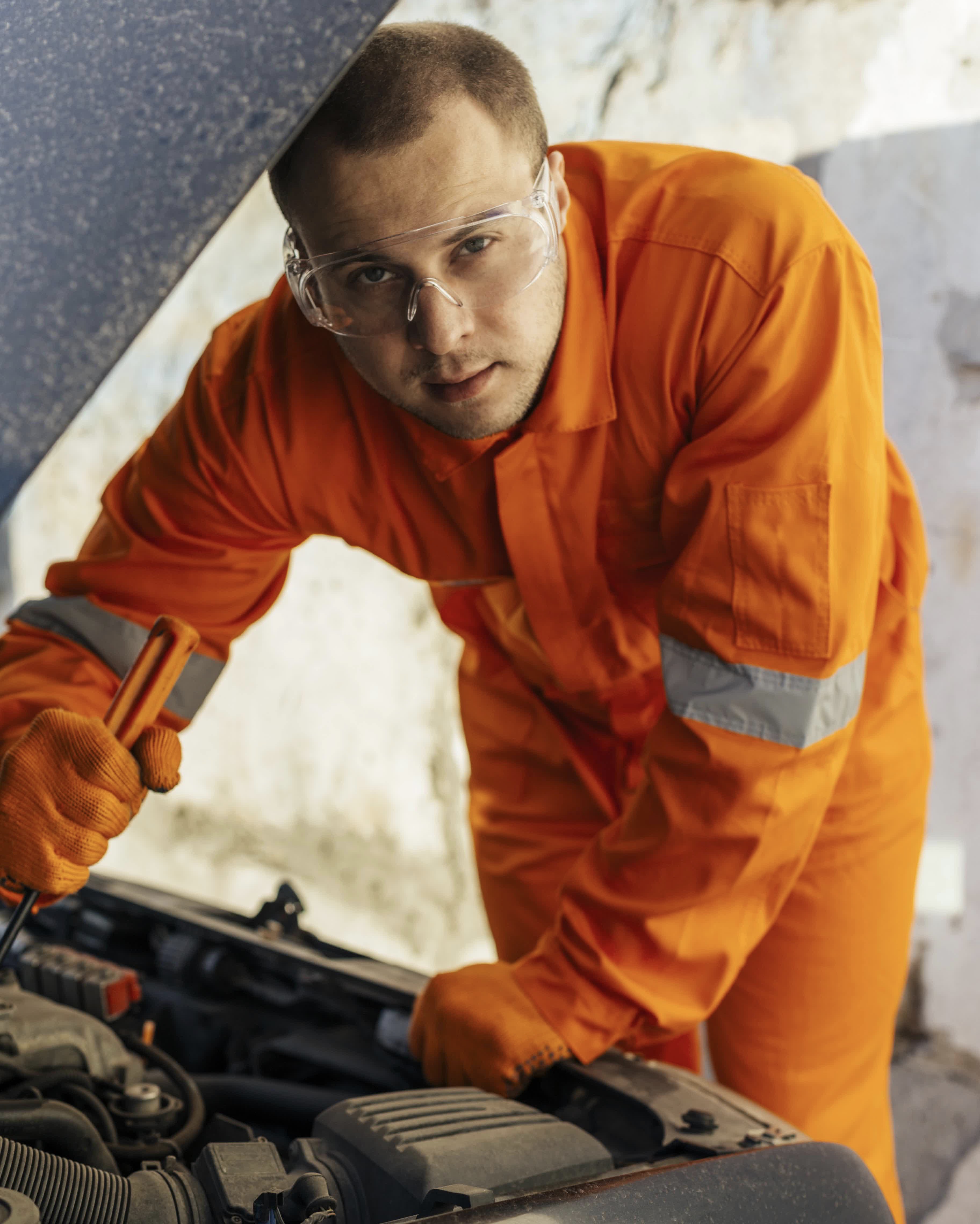 front view-of-mechanic-with-protective-glasses-and-uniform