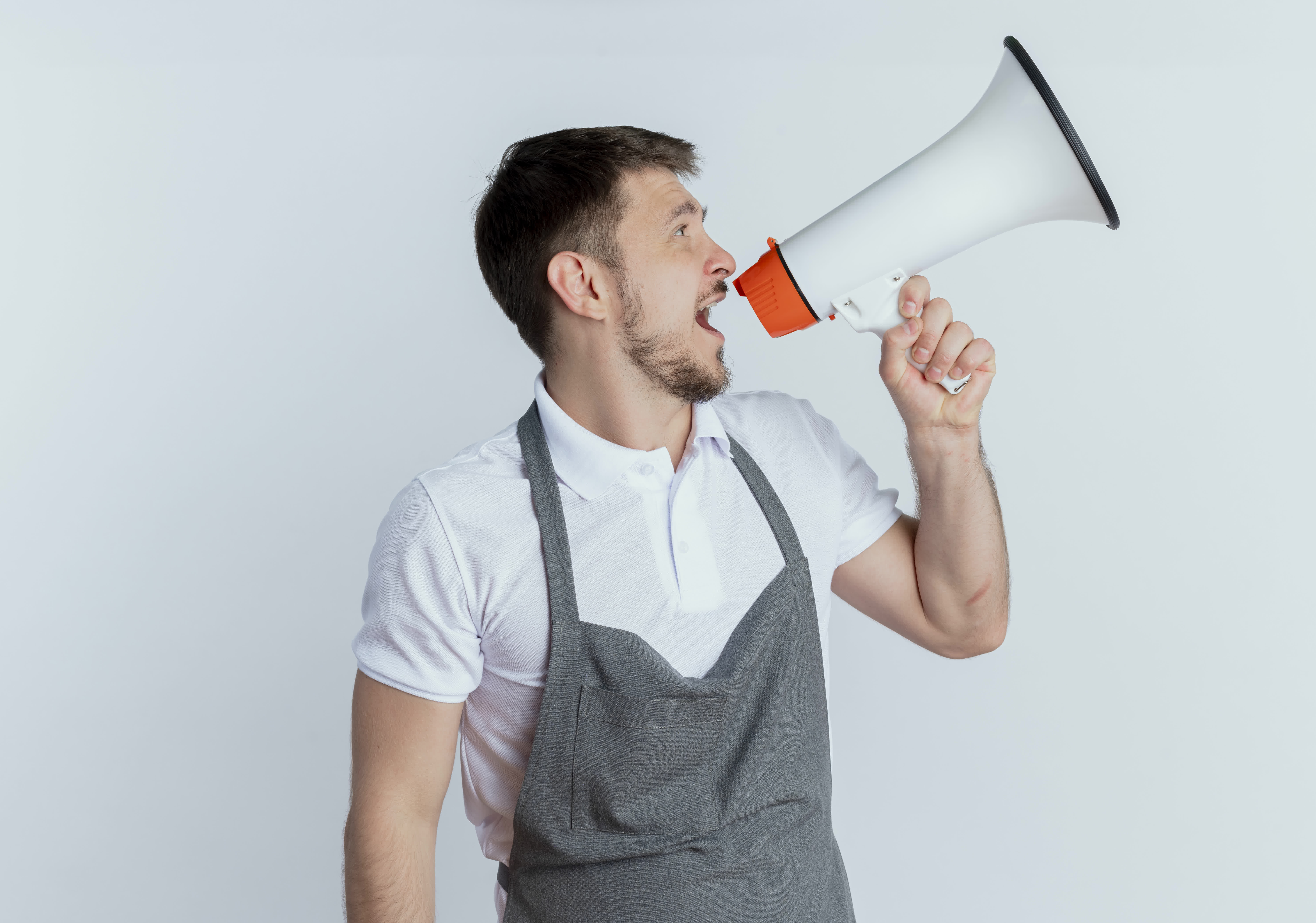 barber man-apron-shouting-megaphone-standing-white-background