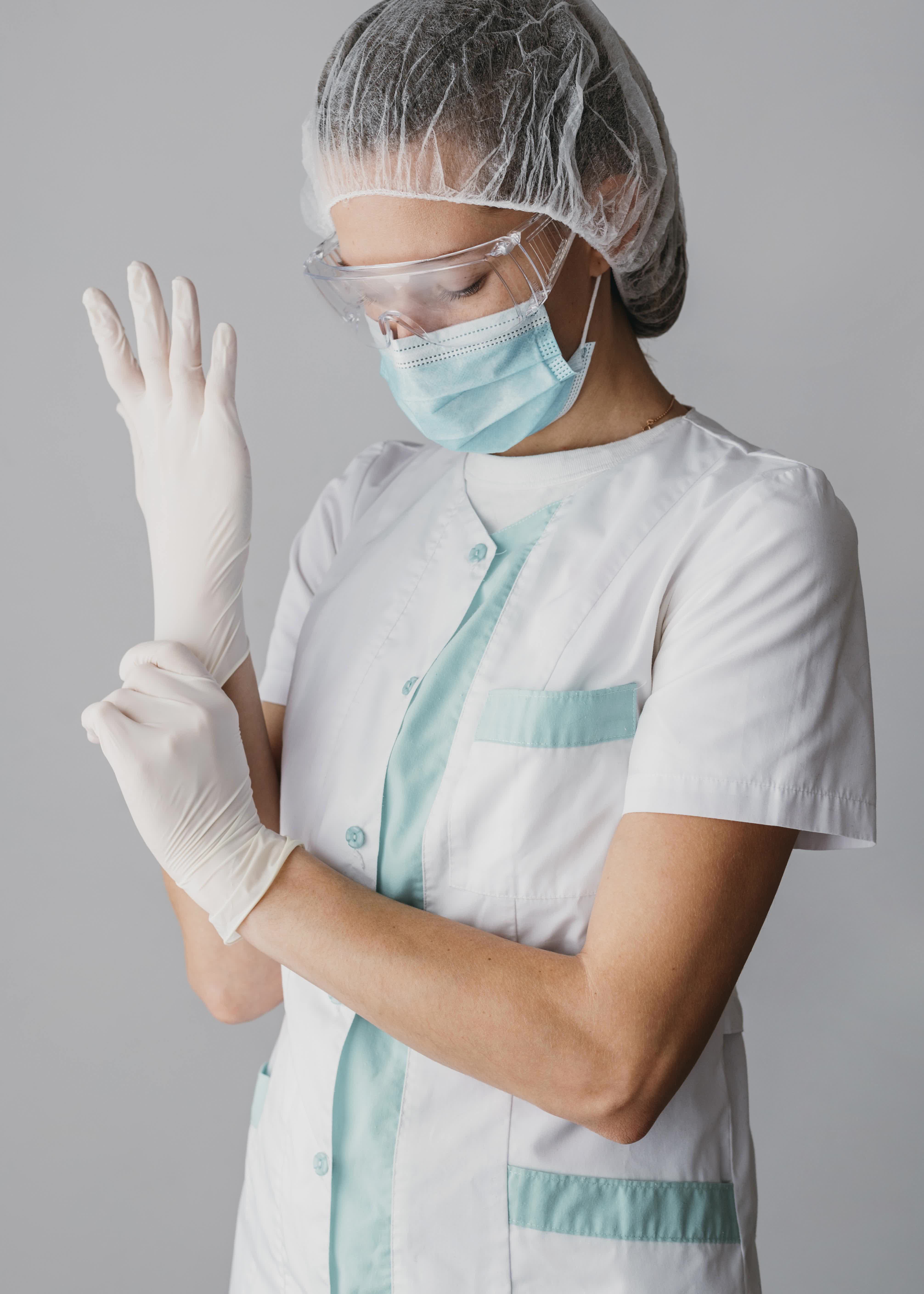 doctor putting-on-surgical-gloves